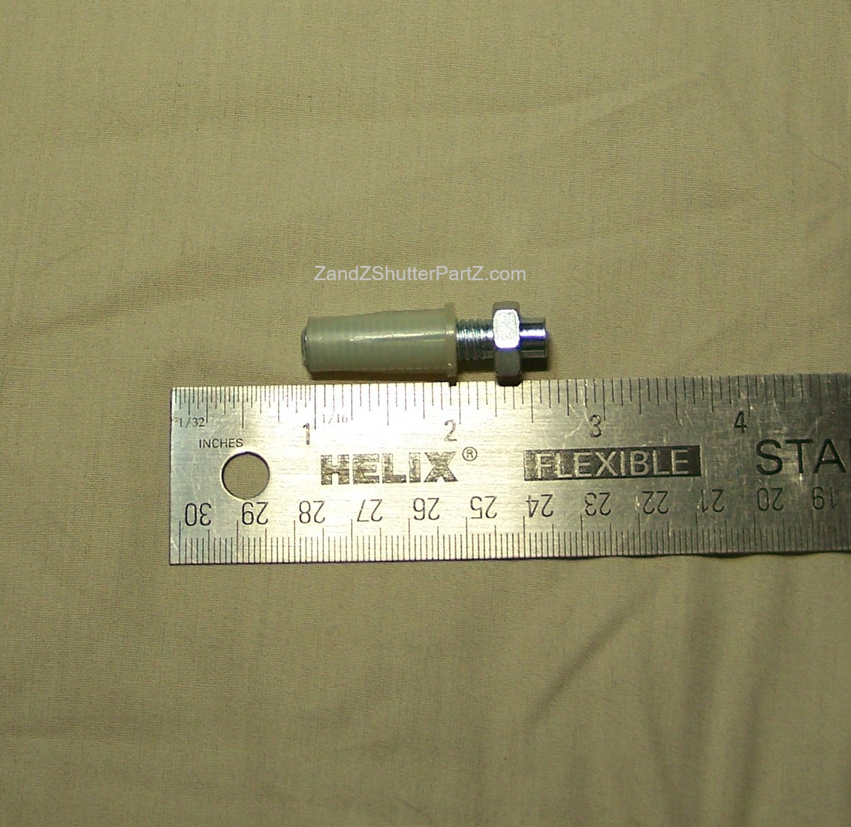 Adjustable Nylon Bottom Pivot shown next to a ruler. Use for Bi-Fold & Bypass Plantation Shutters - Shutter Track Hardware
