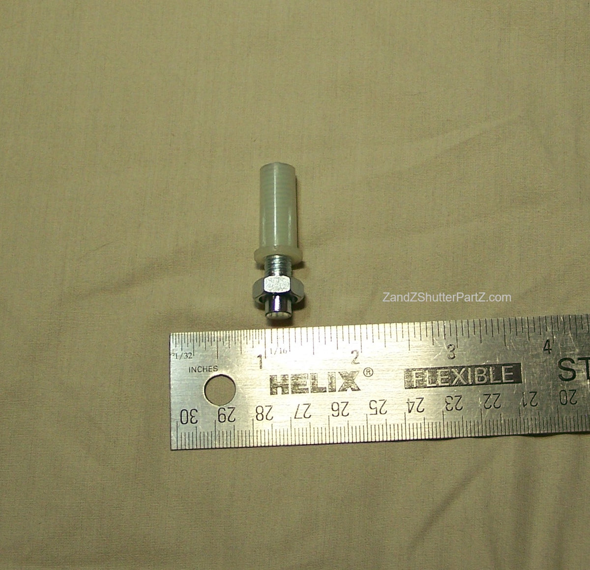 Adjustable Nylon Bottom Pivot shown next to a ruler. Use for Bi-Fold & Bypass Plantation Shutters - Shutter Track Hardware