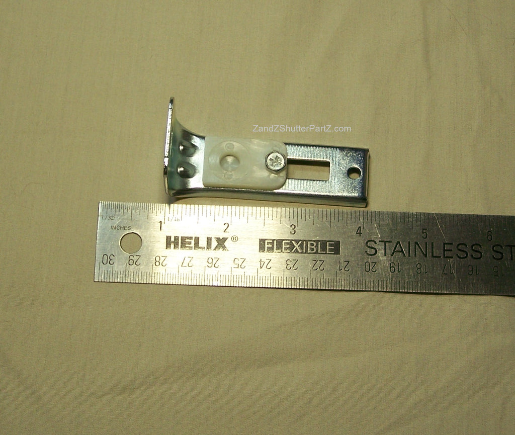Floor Jamb Bracket next to a ruler used for by-fold and bypass plantation shutters