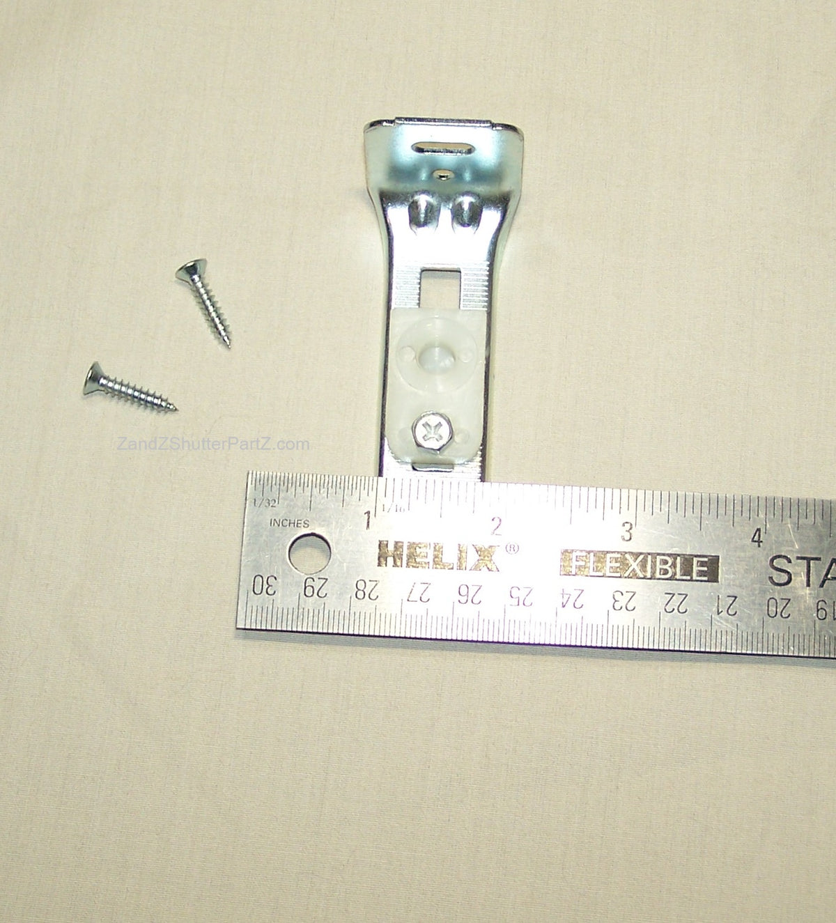 Floor Jamb Bracket next to ruler. Used for by-fold and bypass plantation shutters