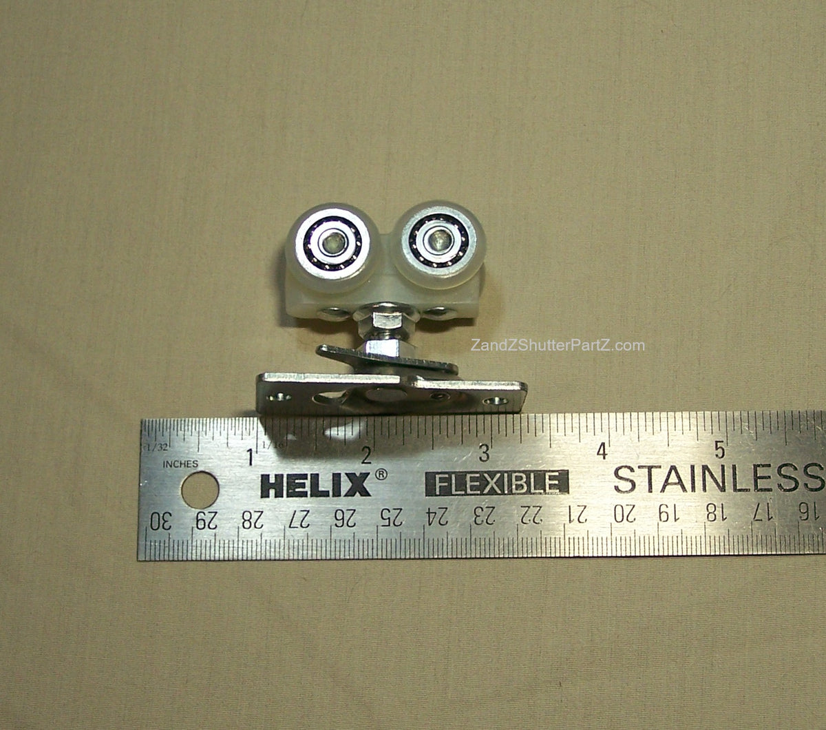 Replacement 4 wheel roller next to ruler