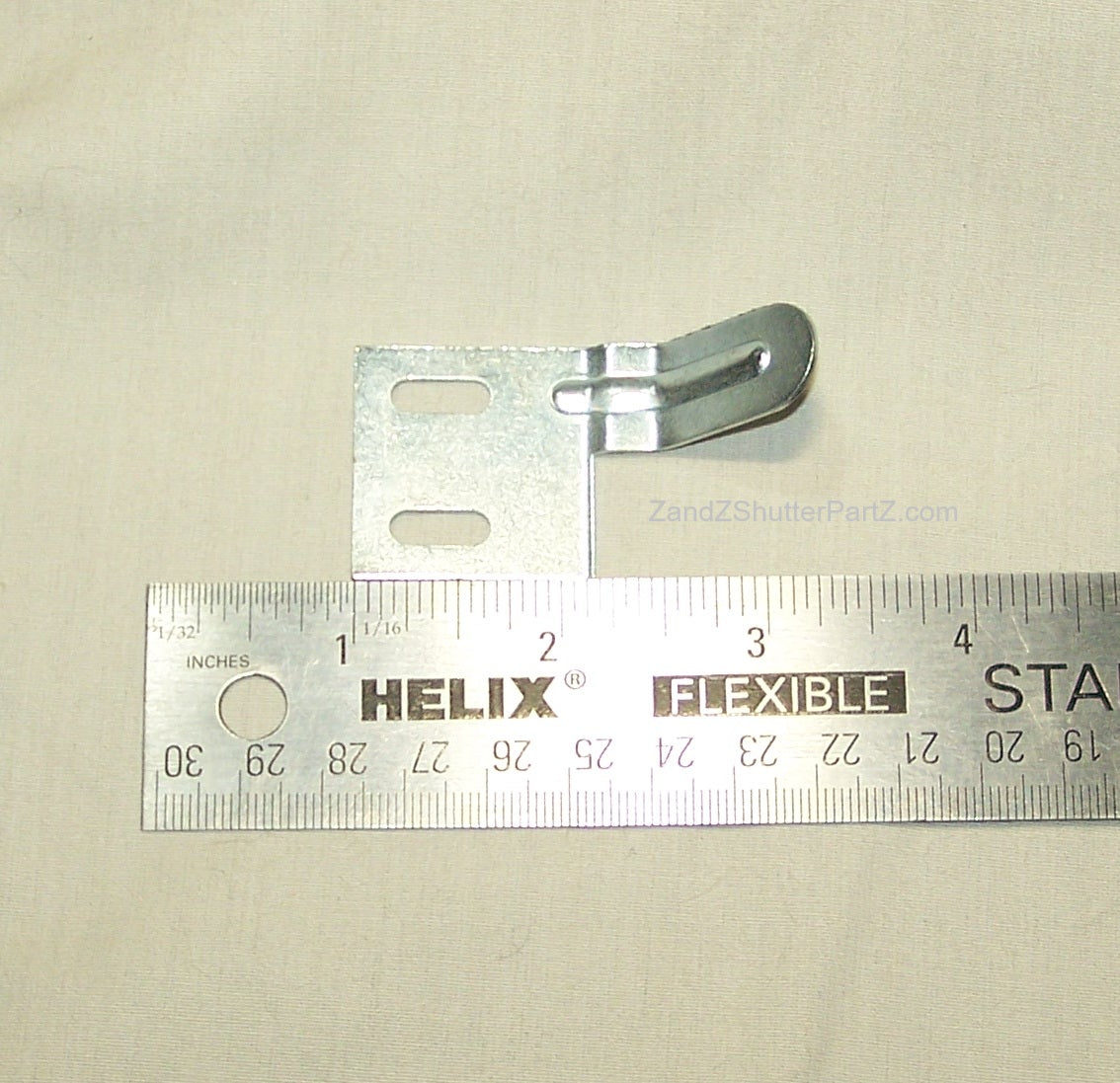 Plantation Shutter Aligner for some by-pass and bi-fold shutters. Part is shown next to a ruler.