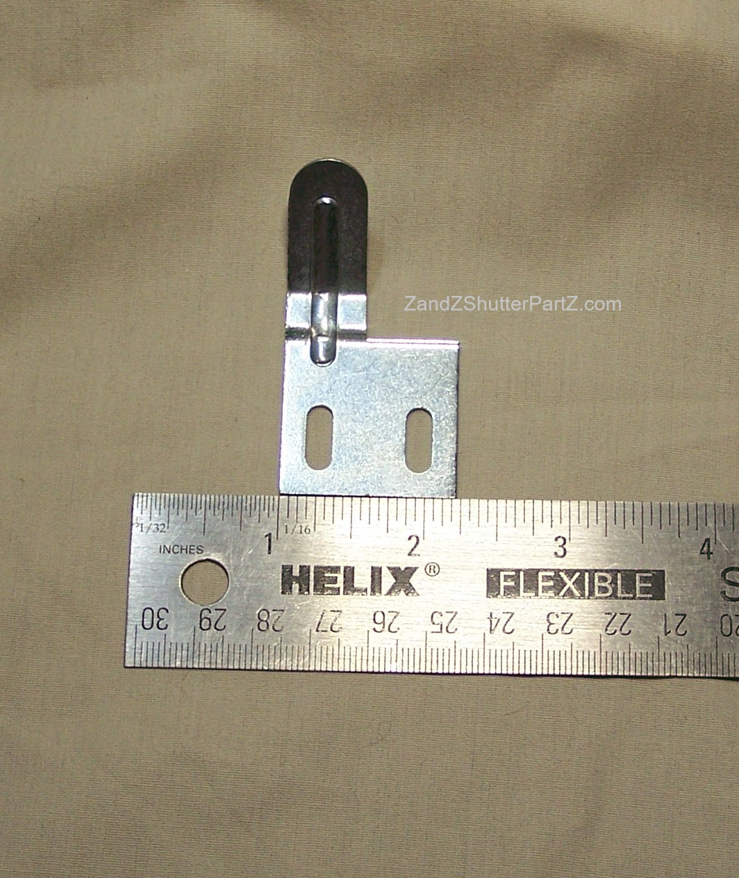 Plantation Shutter Aligner for some by-pass and bi-fold shutters. Part is seen next to a ruler.