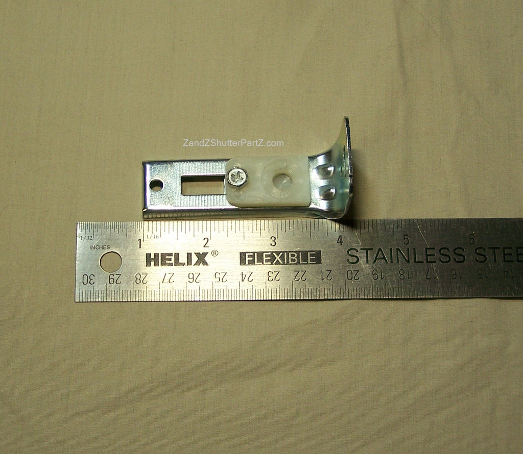 Floor Jamb Bracket next to a ruler. Use for by-fold and bypass plantation shutters